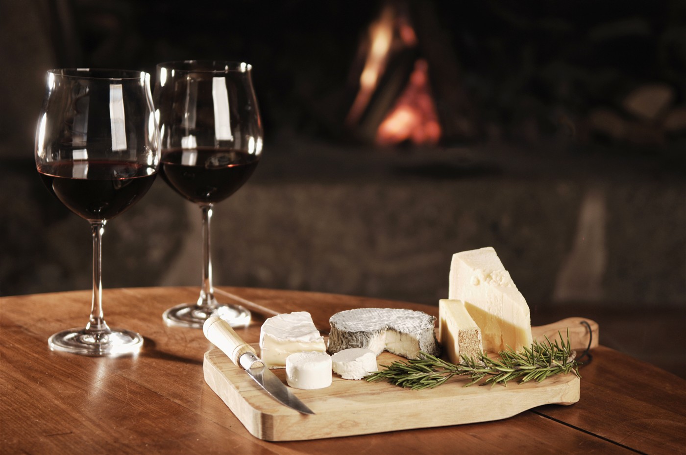 Wine and cheese arranged beside a warm fireplace for the Neighborhood Table restaurant website